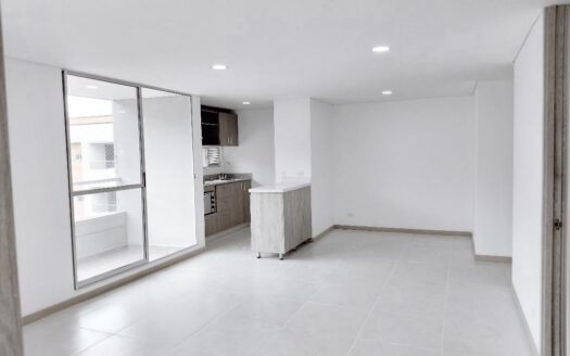 Open-concept living area with a small kitchen island, tiled floor, and sliding glass doors to a balcony outside.