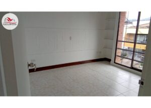 Unfurnished room with a large window/balcony, white walls, built-in shelves, and tiled floor.